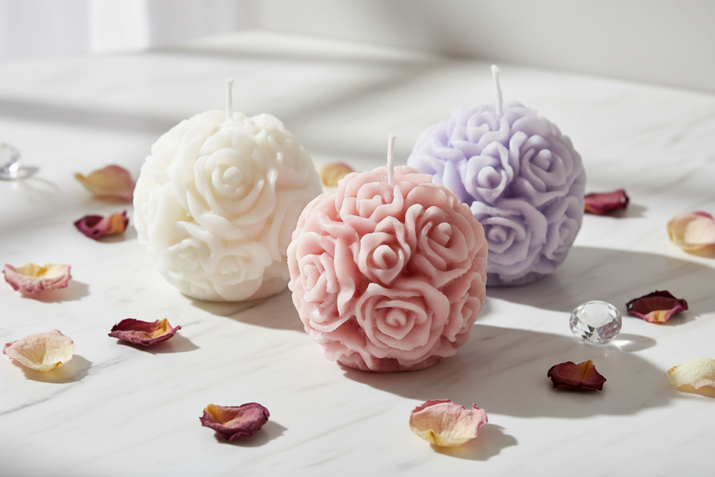 Rose ball sphere candles in white blush pink and lavender group shot on white marble with dried rose petals - Just Natural Purity