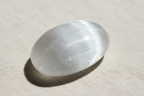 Close-up detail of Selenite Palm Stone showing natural striations