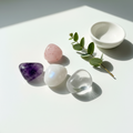 Calm and Peace Crystal Tumble Kit flat lay - Moonstone, Strawberry Quartz, Amethyst, Clear Quartz tumble stones on white surface