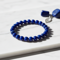 Lapis Lazuli Crystal Bracelet with deep blue beads and golden pyrite on marble