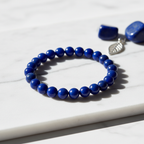 Lapis Lazuli Crystal Bracelet with deep blue beads and golden pyrite on marble