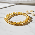 Citrine Crystal Bracelet with sunny yellow golden beads on marble surface
