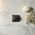 Garnet Pyramid luxury flat lay with marble, flowers and candle