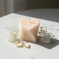 Pastel peach layered heart candle on white marble - Just Natural Purity