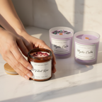 Scented & Spiritual Candle Quad - hand holding Velvet Rose candle with three other candles on white marble