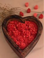 Heart-shaped wooden tray filled with red rose wax candles — real product photo