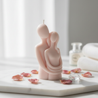 Pastel blush pink couple hugging figurine soy candle on white marble with dried rose petals - Just Natural Purity