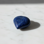Lapis Lazuli Heart Stone with deep blue and golden pyrite on marble