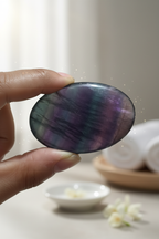 Rainbow Fluorite Palm Stone held in hand showing multicolored clarity energy