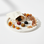 Energy & Vitality Crystal Set - four crystal tumbles spilling from cream cotton potli with orange dried flowers