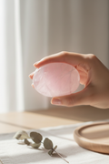 Rose Quartz Palm Stone held in hand showing gentle loving energy