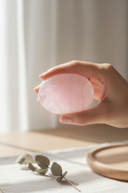 Rose Quartz Palm Stone held in hand showing gentle loving energy