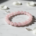 Rose Quartz Crystal Bracelet with soft pink beads on marble surface