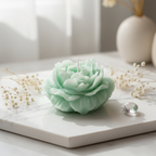 Pastel mint green rose bloom candle on white marble with dried flowers - Just Natural Purity