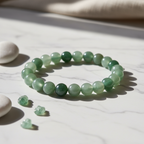 Green Aventurine Crystal Bracelet with soft green beads on marble surface