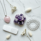Crystal Essentials Gift Set - top-down flat lay with Amethyst, Rose Quartz pendant, Selenite slab and Clear Quartz bracelet on white marble