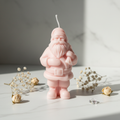 Pastel blush pink Santa Claus figurine candle on white marble - Just Natural Purity