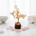 Citrine Crystal Tree on white marble with rose petals