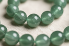 Close-up detail of Green Aventurine beads showing soft green shimmer