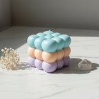 Triple cloud bubble cube candle with pastel sky blue peach and lavender layers on white marble - Just Natural Purity