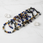 Clarity Growth Money Authority crystal bracelet flat lay - 8 bracelets on white marble - Just Natural Purity
